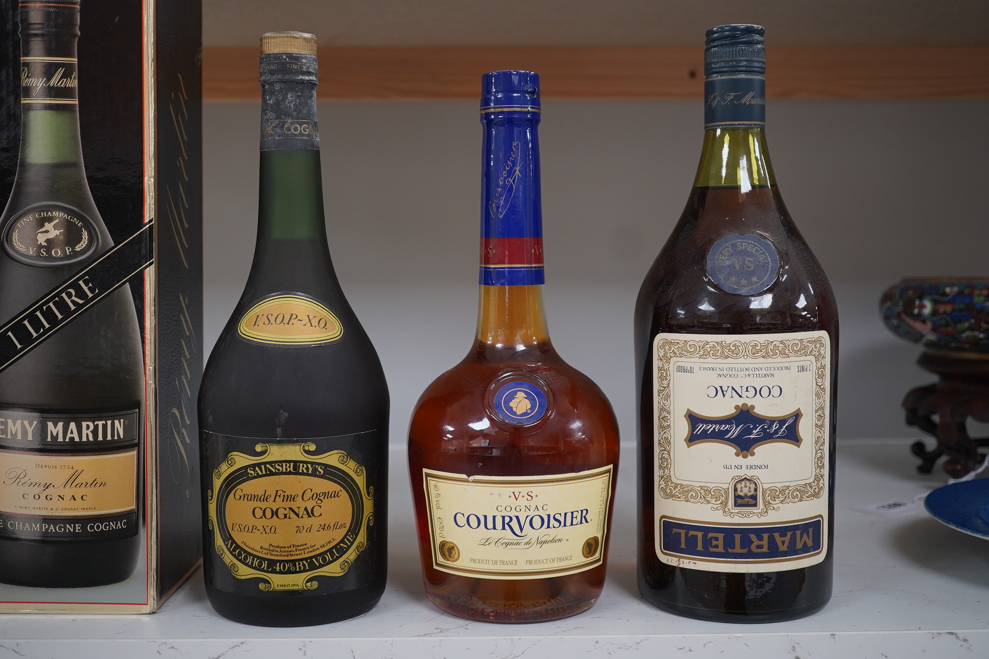 Seven various bottles of cognac to include a boxed bottle of Remy Martin, Courvoisier. Condition - unknown how stored